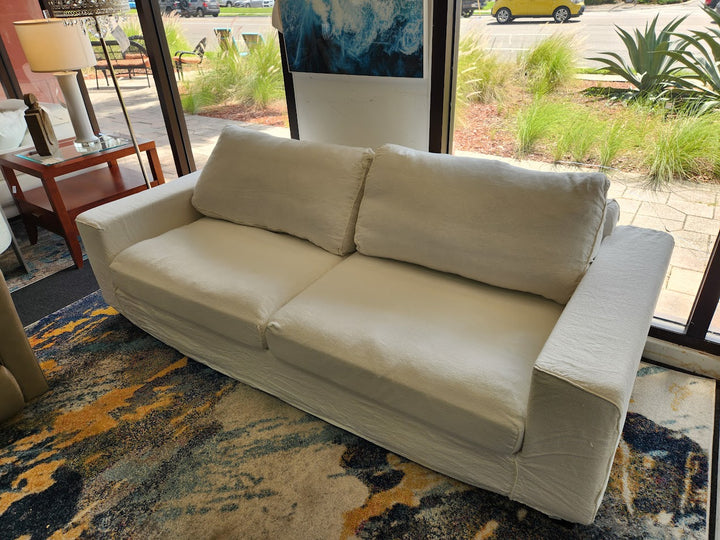 White linen slipcovered sofa