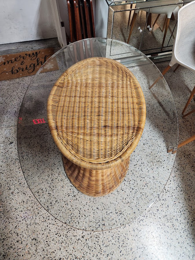 Hourglass-shaped wicker and rattan dining table