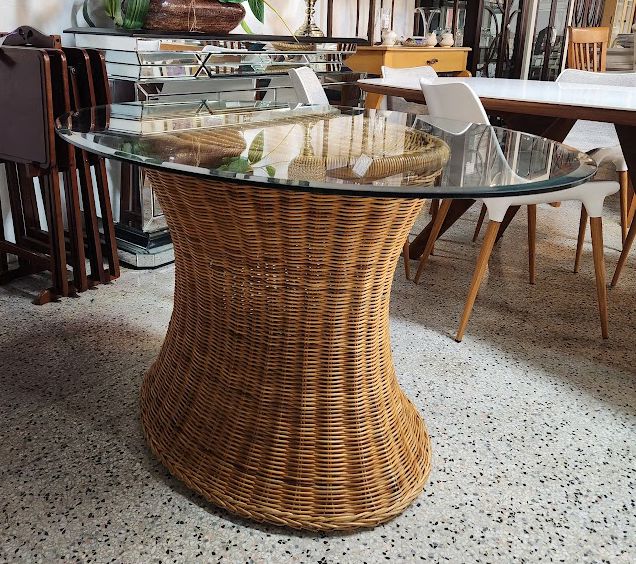 Hourglass-shaped wicker and rattan dining table