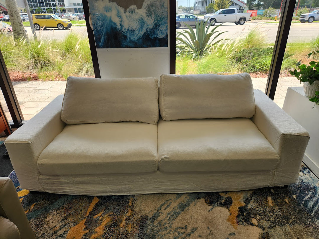 White linen slipcovered sofa