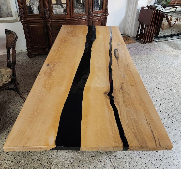 Live-edge wooden dining table w/black epoxy