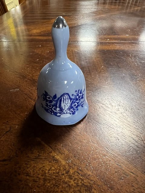 Blue hand bell with prayer hand design