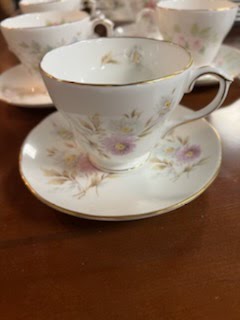 Tea cup and saucer, white and purple flowers