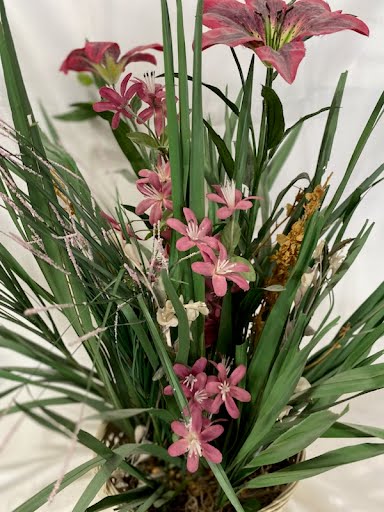 Pink flower floral arrangement w/ basket