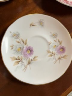 Tea cup and saucer, white and purple flowers
