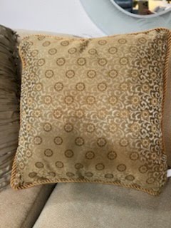 Gold throw pillow with circular flower design