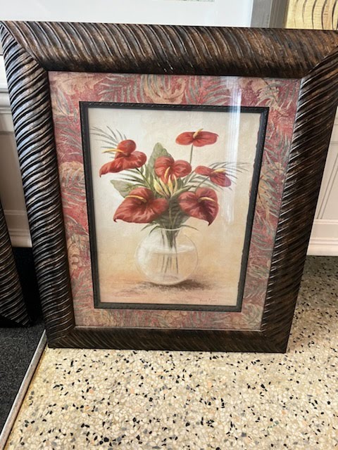 Brown wood frame with red flowers in clear vase