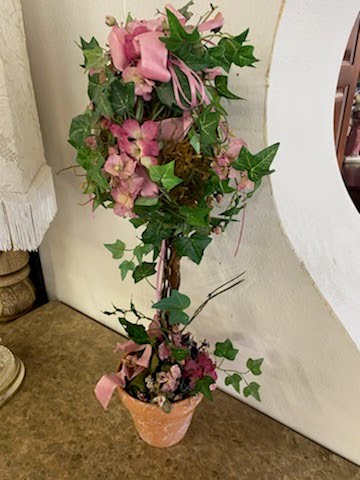 Pink floral arrangement & greenery in clay pot