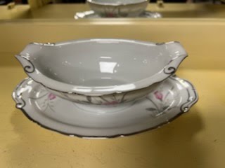 Gravy boat with attached plate
