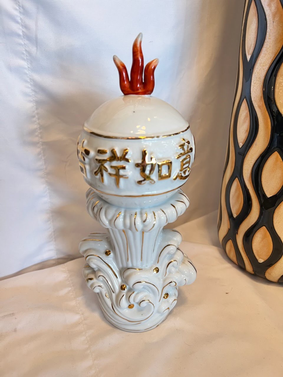 Porcelain decor with red flame on top
