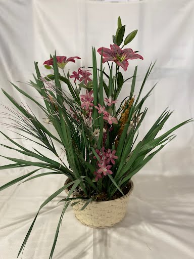Pink flower floral arrangement w/ basket