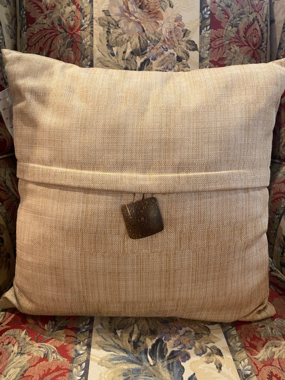 Tan pillow with brown button